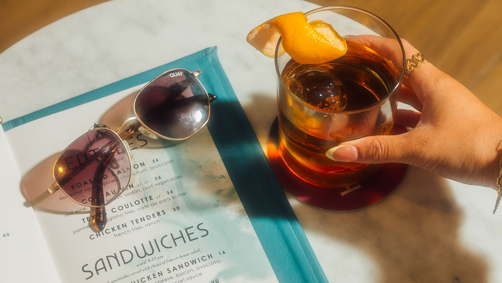 High praise menu with craft cocktail and sunglasses