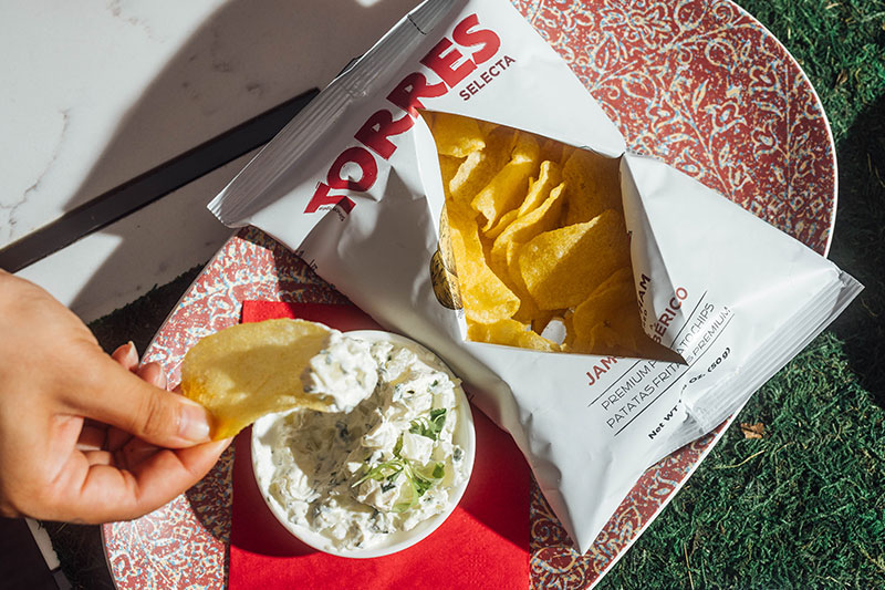 Image of chips, dip, and cocktail